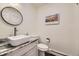 Stylish powder room with a vessel sink, granite countertop, and modern fixtures at 6451 Crestbrook Dr, Morrison, CO 80465