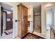Bathroom featuring wood cabinets and shower with tile surround at 6451 Crestbrook Dr, Morrison, CO 80465