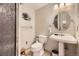 Small bathroom with pedestal sink and enclosed shower at 6451 Crestbrook Dr, Morrison, CO 80465