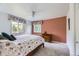 Cozy bedroom with two windows, ceiling fan, and floral accents at 6451 Crestbrook Dr, Morrison, CO 80465