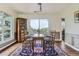Dining room with wooden table set for six, lovely hardwood floors and a big window at 6451 Crestbrook Dr, Morrison, CO 80465