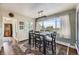 Bright dining room featuring a modern light fixture, large windows, and an elegant area rug at 6451 Crestbrook Dr, Morrison, CO 80465