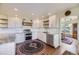 Modern kitchen with stainless steel appliances, white cabinets, granite countertops, and hardwood floors at 6451 Crestbrook Dr, Morrison, CO 80465