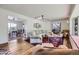 Bright living room with hardwood floors, a cozy seating arrangement, and natural lighting at 6451 Crestbrook Dr, Morrison, CO 80465