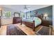 Serene bedroom featuring hardwood floors, a ceiling fan, and ample natural light at 6451 Crestbrook Dr, Morrison, CO 80465
