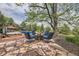 Relaxing backyard patio with firepit, lounge chairs, and view of the pool and beautiful landscaping at 6451 Crestbrook Dr, Morrison, CO 80465