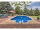 Beautiful pool with an umbrella and lounge chairs at 6451 Crestbrook Dr, Morrison, CO 80465