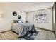 Sunlit bedroom featuring carpeted floors and views of the surroundings from a window at 940 Coronado S Pkwy # A, Denver, CO 80229