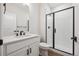 Modern bathroom features a white vanity and a shower with black trim and white subway tile at 5549 Riverbend Ave, Firestone, CO 80504