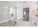 Luxurious bathroom featuring a soaking tub with a glass enclosure and sleek double vanity with marble accents at 5549 Riverbend Ave, Firestone, CO 80504