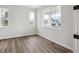 Inviting bedroom with hardwood floors, light walls, and bright windows at 5549 Riverbend Ave, Firestone, CO 80504