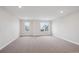 Large, carpeted bedroom with great natural light from multiple windows at 5549 Riverbend Ave, Firestone, CO 80504