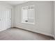 Cozy bedroom with a window, a closet with sliding doors, and neutral carpeting for a comfortable atmosphere at 5549 Riverbend Ave, Firestone, CO 80504