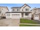 Charming two-story home with a three-car garage and well-manicured front lawn at 5549 Riverbend Ave, Firestone, CO 80504