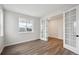 Bright living room with hardwood floors and elegant glass paneled french doors at 5549 Riverbend Ave, Firestone, CO 80504
