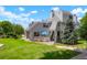 Exterior angle of condo with well-kept grass, charming deck, and mature trees and shrubs at 8701 Huron St # 2-106, Thornton, CO 80260