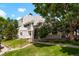 Multi-level condo exterior with a lush green lawn, mature trees, and well-kept landscaping at 8701 Huron St # 2-106, Thornton, CO 80260