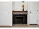 Cozy fireplace with mantel, flanked by storage closets and doors at 8701 Huron St # 2-106, Thornton, CO 80260