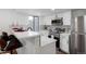 Modern kitchen featuring stainless steel appliances, white cabinetry and a breakfast bar with seating at 8701 Huron St # 2-106, Thornton, CO 80260