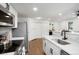 Modern kitchen with stainless steel appliances, white cabinets, and stylish backsplash for cooking enthusiasts at 8701 Huron St # 2-106, Thornton, CO 80260
