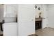 Efficient laundry area with stacked washer and dryer, and a view of fireplace at 8701 Huron St # 2-106, Thornton, CO 80260