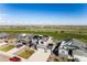 Panoramic aerial view of a suburban home featuring a large lot and beautiful views of a green space at 2355 Saddle Back Ct, Fort Lupton, CO 80621
