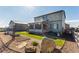 Landscaped backyard featuring a manicured lawn, charming garden beds, and partial view of the home's exterior at 2355 Saddle Back Ct, Fort Lupton, CO 80621