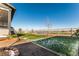Landscaped backyard featuring lush grass, a well-kept fence, and partial view of the home's exterior at 2355 Saddle Back Ct, Fort Lupton, CO 80621