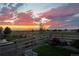 Beautiful backyard with well-manicured lawn, flower garden and stunning sunset views at 2355 Saddle Back Ct, Fort Lupton, CO 80621