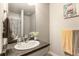 Bathroom featuring a white vanity, a dark countertop, and neutral colored towels at 2355 Saddle Back Ct, Fort Lupton, CO 80621