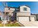 Charming two-story home showcasing a three-car garage, well-manicured lawn, and inviting curb appeal at 2355 Saddle Back Ct, Fort Lupton, CO 80621