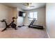 Home gym space with a treadmill, stationary bike, and weight set near window at 2355 Saddle Back Ct, Fort Lupton, CO 80621