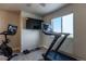Home gym with workout equipment including a stationary bike and treadmill at 2355 Saddle Back Ct, Fort Lupton, CO 80621
