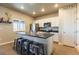 Modern kitchen with stainless steel appliances, white cabinets, and center island with seating at 2355 Saddle Back Ct, Fort Lupton, CO 80621