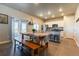 Bright open kitchen with modern appliances, an island, and sliding glass doors to the backyard at 2355 Saddle Back Ct, Fort Lupton, CO 80621