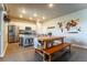Bright kitchen featuring stainless steel appliances and views of the dining area and backyard at 2355 Saddle Back Ct, Fort Lupton, CO 80621