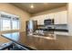 Well-lit kitchen with island, stainless steel appliances, and ample counter space for cooking at 2355 Saddle Back Ct, Fort Lupton, CO 80621