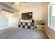 Comfortable living space with plush carpeting, a large TV, and cubby storage space at 2355 Saddle Back Ct, Fort Lupton, CO 80621