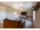 Cozy living room with plush carpet, entertainment center, and a ceiling fan at 2355 Saddle Back Ct, Fort Lupton, CO 80621