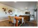 Open concept dining and living area featuring wood floors and a comfortable couch at 2355 Saddle Back Ct, Fort Lupton, CO 80621