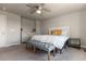 Cozy main bedroom featuring neutral walls, ceiling fan, and stylish bench at the foot of the bed at 2355 Saddle Back Ct, Fort Lupton, CO 80621