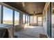 Inviting sunroom featuring large windows with scenic views, ceiling fan, and access to the backyard at 2355 Saddle Back Ct, Fort Lupton, CO 80621