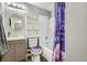 Cozy bathroom featuring a shower-tub combo with stylish purple shower curtain and decorative sink at 1165 S Fairplay Cir # B, Aurora, CO 80012