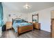 Bright bedroom is furnished with a wooden bed frame, matching nightstands, and laminate floors at 1165 S Fairplay Cir # B, Aurora, CO 80012