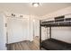Bedroom with wood-look floors, bunk beds, and a large white wardrobe with bi-fold doors at 1165 S Fairplay Cir # B, Aurora, CO 80012
