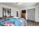 Cozy bedroom includes a vintage wooden dresser with closet and TV at 1165 S Fairplay Cir # B, Aurora, CO 80012