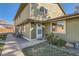 Charming townhome featuring light green siding and a well-maintained lawn leading to the front door on a sunny day at 1165 S Fairplay Cir # B, Aurora, CO 80012