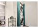 Hall laundry closet featuring a stacked washer and dryer and wire shelving for storage at 1165 S Fairplay Cir # B, Aurora, CO 80012