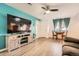 Bright living room featuring wood floors, a dining nook, and a view of the front yard through the windows at 1165 S Fairplay Cir # B, Aurora, CO 80012