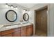 Bright bathroom featuring double sink vanity with granite counters and tiled shower at 3570 E Arapahoe Pl, Centennial, CO 80122